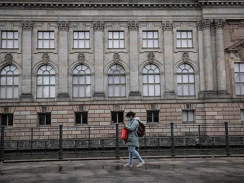A women passes by the Bode museum, part of the Museum Island, in Berlin on October 21, 2020. According to media reports, dozens of works of art were damaged by unknown persons on Berlin's Museum Island on the Unification Day.