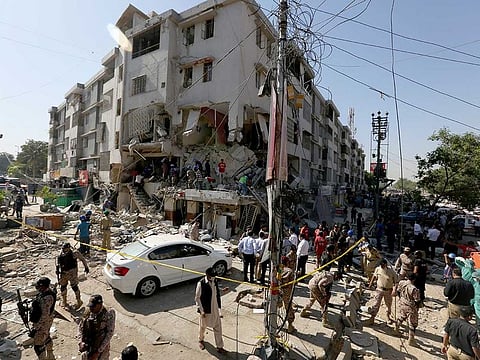 Pakistan's troops and rescue workers look for survivors amid the rubble following the explosion, in Karachi, Pakistan, Wednesday, Oct. 21, 2020.