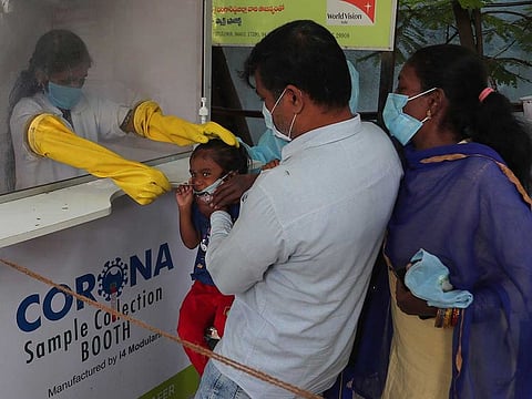 A health worker takes a nasal swab sample at a COVID-19 testing centre in Hyderabad, India, Friday, Oct. 23, 2020. 