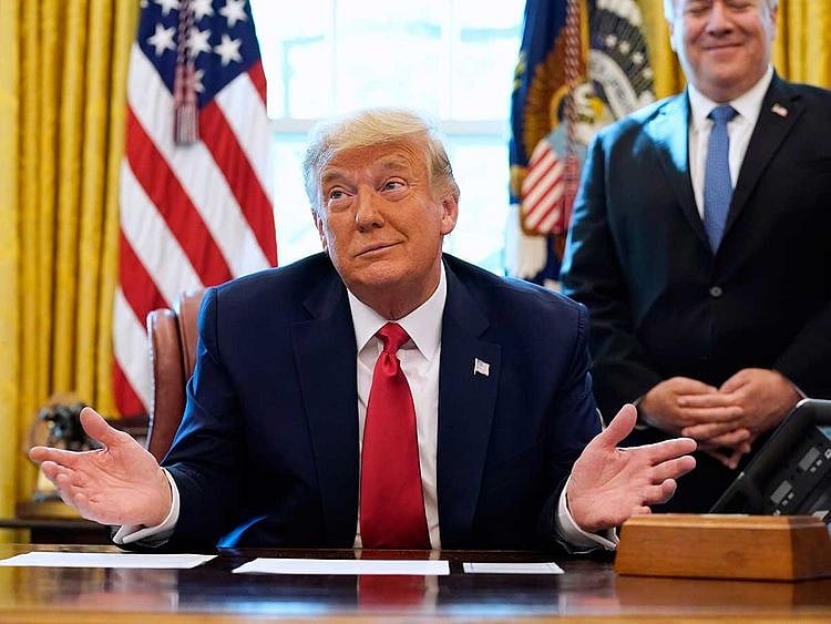 President Donald Trump listens while on a phone call with the leaders of Sudan and Israel, in the Oval Office of the White House, Friday, Oct. 23, 2020, in Washington