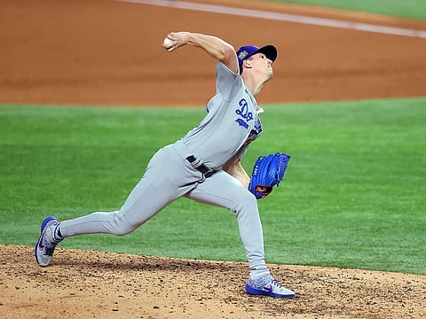  Walker Buehler of the Los Angeles Dodgers delivers against the Tampa Bay Rays during the fifth inning in Game Three of the 2020 MLB World Series at Globe Life Field in Texas