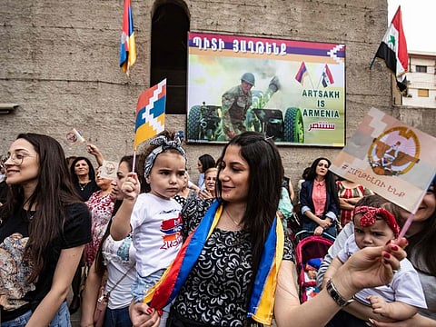 Members of the Syrian Armenian minority take part in a rally in the Kurdish-majority city of Qamishli in Syria's northeastern Hasakeh province, to express solidarity with fellow Armenians, engaged in a war over the disputed territory of Nagorno-Karabakh, on October 25, 2020. 