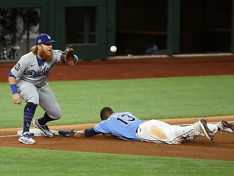  Tampa Bay Rays left fielder Manuel Margot (13) reaches third base ahead of the tag by Los Angeles Dodgers third baseman Justin Turner