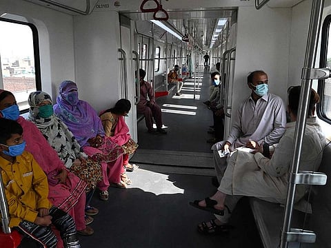 Passengers ride in a newly built Orange Line Metro Train (OLMT), a metro project planned under the China-Pakistan Economic Corridor (CPEC), a day after an official opening in the eastern city of Lahore on October 26, 2020. 