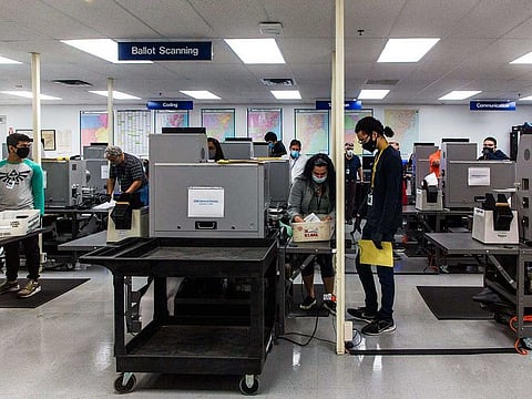 Mail-in ballots are counted at the Miami-Dade County Elections Department in Florida, Oct. 19, 2020. In the final stretch of the 2020 campaign, right-leaning news sites with millions of readers have published dozens of false or misleading headlines and articles that effectively back unsubstantiated claims by President Donald Trump and his allies that mail-in ballots threaten the integrity of the election. 