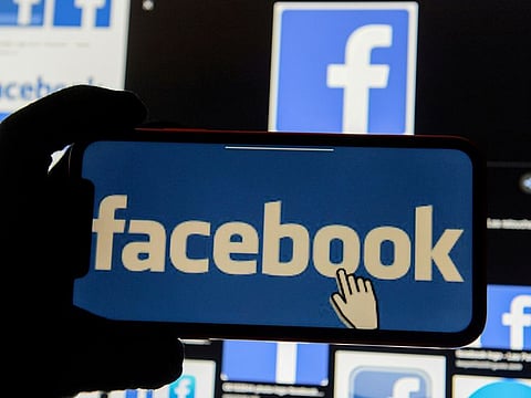 The Facebook logo displayed on a mobile phone.