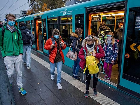  Students wear face masks as they leave a subway in Frankfurt, Germany, Wednesday, Oct. 28, 2020. 