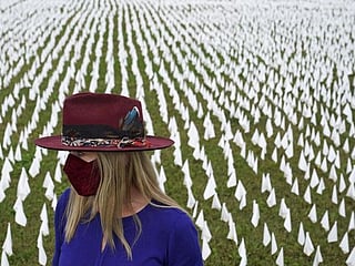 In Pictures: Art installation commemorates American lives lost from virus with planting of white flags