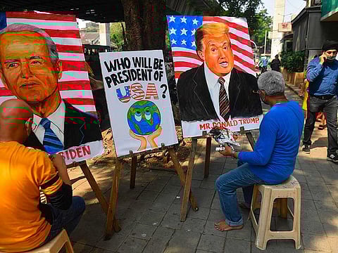 Indian art school teachers paint images of US President Donald Trump and Democratic Presidential Candidate and former US Vice President Joe Biden ahead of the upcoming US presidential elections, outside an art school in Mumbai 
