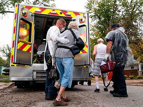 Firefighters and paramedics with Anne Arundel County Fire Department wear enhanced Personal Protective Equipment as they assist confirmed Covid-19 positive patients in Glen Burnie, Maryland.