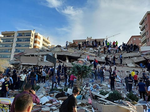 Locals and officials search for survivors at a collapsed building after a strong earthquake struck the Aegean Sea on Friday and was felt in both Greece and Turkey, where some buildings collapsed in the coastal province of Izmir, Turkey, October 30, 2020