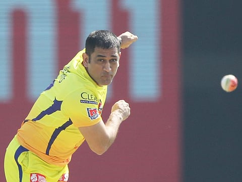 Chennai Super Kings skipper MS Dhoni rolls his arm over on the eve of their IPL match against Kings XI Punjab on Sunday.
