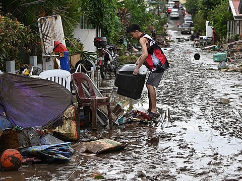 Residents clean their homes following flooding in Batangas City, south of Manila on November 2, 2020, after super Typhoon Goni made landfall in the Philippines on November 1.