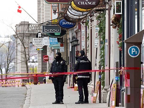 Polices officers guard the site of a multiple stabbing in the historical quarter of Quebec City, Sunday, Nov. 1, 2020. 