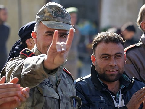In this file photo taken on December 21, 2018, a man wearing a Turkish officer's uniform flashes the Grey Wolves (a Turkish far-right ultranationalist organisation) sign, during a demonstration in support of Turkey in the Syrian town of Bizaa. France is to ban Grey Wolves, the interior minister said on November 2, 2020, after a memorial to the mass killings of Armenians was defaced at the weekend. 