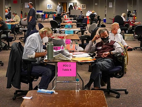 Workers count ballots at the Central Count Facility in Milwaukee, Wis., Nov. 3, 2020. 