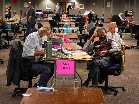 Workers count ballots at the Central Count Facility in Milwaukee, Wis., Nov. 3, 2020. 