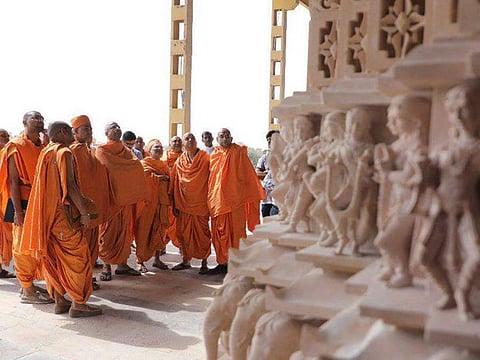 Stone pillars for the Abu Dhabi Hindu temple being inspected by temple priests at artisans’ worksite in India. The intricate carvings of the mandir range from figurines only a few inches tall to statues of many meters.
