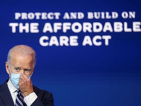 U.S. President-elect Joe Biden adjusts his face mask after during a brief news conference, where he discussed health care and the Affordable Care Act (Obamacare, at the theater serving as his transition headquarters in Wilmington, Delaware, U.S., November 10, 2020.