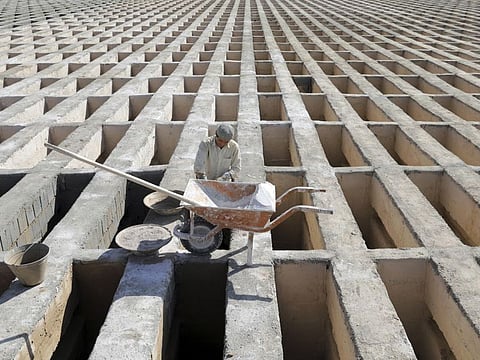 A cemetery worker prepares new graves at the Behesht-e-Zahra cemetery on the outskirts of the Iranian capital, Tehran.