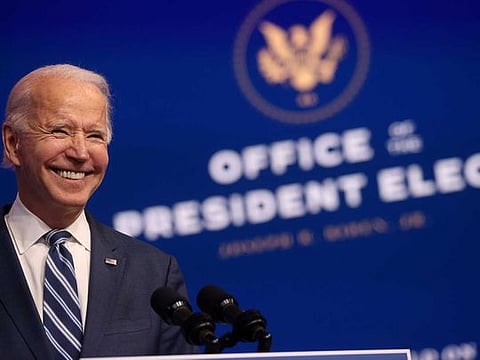 US President-elect Joe Biden smiles as he speaks about health care and the Affordable Care Act (Obamacare) at the theatre serving as his transition headquarters in Wilmington, Delaware, US, November 10, 2020. 