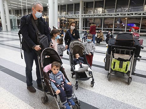 Dr. Fouad Boulos, Associate Professor of Clinical Pathology and Laboratory Medicine at the American University of Beirut (AUB) pushes a baby cart near his wife and children, at Beirut International airport, in Beirut, Lebanon November 6, 2020. Picture taken November 6, 2020