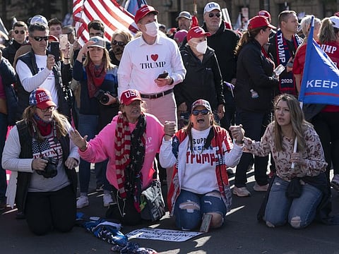 Demonstrators pray during the "Million MAGA March" at Freedom Plaza in Washington, D.C. on Saturday, November 14, 2020. 