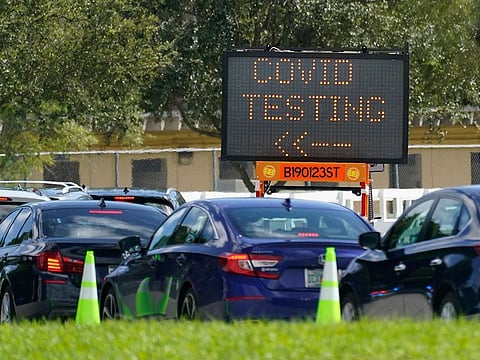 Cars line up at a COVID-19 testing site at Tropical Park, in Miami, Florida. 