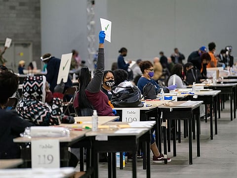 Workers recount election ballots by hand at the Georgia World Congress Center in Atlanta.