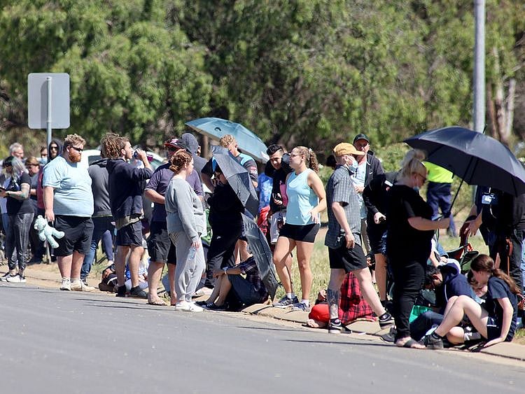 People are seen queuing at a COVID-19 testing site
