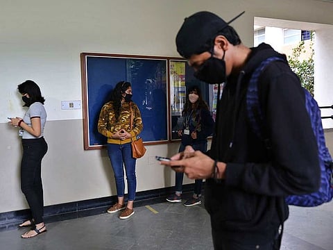 Students wearing face masks as a precaution against the coronavirus line up to be tested for COVID-19 at St. Joseph's College in Bengaluru, India, Monday, Nov.16, 2020. 