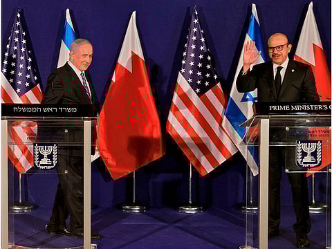 Israeli Prime Minister Benjamin Netanyahu approaches Bahrain's Foreign Minister Abdullatif bin Rashid Al Zayani during a press conference after their trilateral meeting in Jerusalem