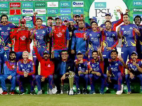 Karachi Kings officials and players pose with the winning trophy after the final of the Pakistan Super League (PSL) T20 cricket match against Lahore Qalandars at National Stadium in Karachi, on November 17, 2020. 