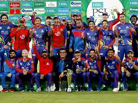 Karachi Kings officials and players pose with the winning trophy after the final of the PSL 2020 in Pakistan.