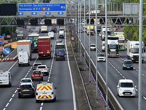  In this May 18, 2020, file photo, traffic moves along the M6 motorway near Birmingham, England. Britain will ban the sale of new gasoline and diesel cars by 2030, a decade earlier than its previous commitment, the prime minister said Tuesday, Nov. 17, 2020. 