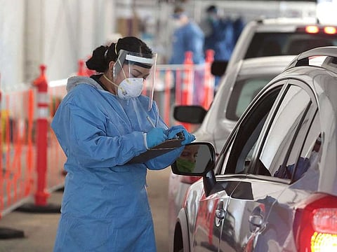 A member of the Wisconsin National Guard helps to test residents for COVID-19 at a drive-up test center at Miller Park on November 17, 2020 in Milwaukee, Wisconsin. 