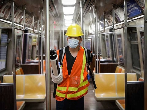 In this July 2, 2020, file photo, a contractor uses an electrostatic sprayer to disinfect subway cars to control the spread of COVID-19, in New York. The New York Metropolitan Transportation Authority has embarked on an aggressive cleaning and disinfecting programme that will wind up costing it more than $1 billion, according to MTA officials. 