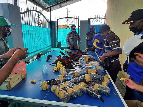 Officials freeing dozens of parrots after they were found stuffed in plastic water bottles on a ship docked in Fakfak in Indonesia’s West Papua region. 