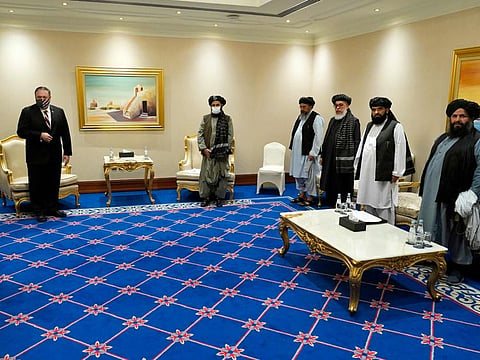 US Secretary of State Mike Pompeo meets with Taliban co-founder Mullah Abdul Ghani Baradar (centre-right) and negotiators in Doha on November 21, 2020. 