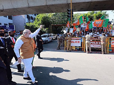 Union Home Minister Amit Shah waves his supporters as he arrives in Chennai on Saturday. 
