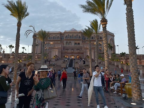 Tourists in front of the Emirates Palace in Abu Dhabi last year. Picture for illustrative purposes only.