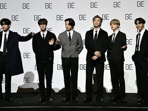 South Korean K-pop boy band BTS members (L to R) V, Jin, Jung Kook, RM, Jimin and J-Hope pose for a photo session during a press conference on BTS new album 'BE (Deluxe Edition)' in Seoul on November 20, 2020.