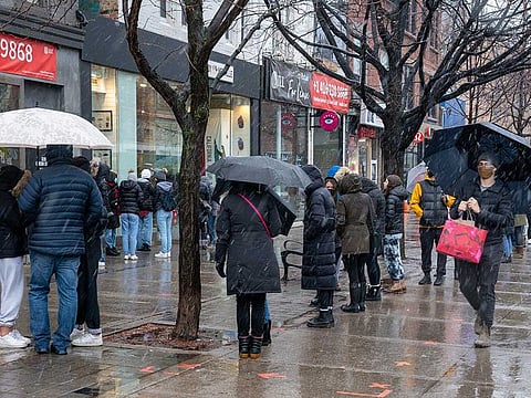 Crowds of people line up outside a clothing store in Toronto on Sunday, Nov. 22, 2020. The region is heading back into lockdown on Monday. 