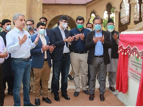  Karachi's Administrator Iftikhar Ali Shallwani and other officials pray after formally launching the project to renovate Frere Hall building.
