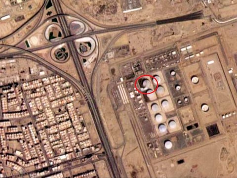 A damaged tank and fire-suppressing foam on the ground at a Saudi Arabian Oil Co. facility in Jeddah, Saudi Arabia. 