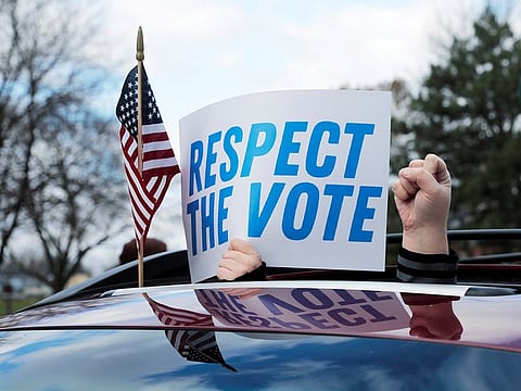 Demonstrators in a car caravan demand the Board of State Canvassers to certify the results of the election in Lansing, Michigan, U.S., November 23, 2020.  
