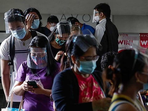 People wearing face masks and face shields to prevent the spread of COVID-19.