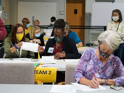 Workers recount election ballots by hand in Gwinnett County, Georgia on Friday, Nov. 13, 2020.