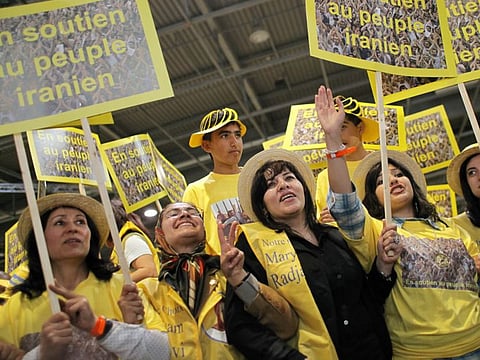 In this June 20, 2009 file photo, Iranians applaud Maryam Rajavi, leader of the National Council of Resistance of Iran at a rally in Villepinte, a northern suburb of Paris. Four people are going on trial in the Belgian city of Antwerp on Friday November 27, 2020, accused of planning to bomb a rally of Iranian opposition supporters. 