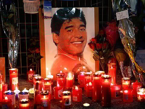 Candles and flowers are seen outside the San Paolo stadium commemorating soccer legend Diego Maradona in Naples on Thursday.
